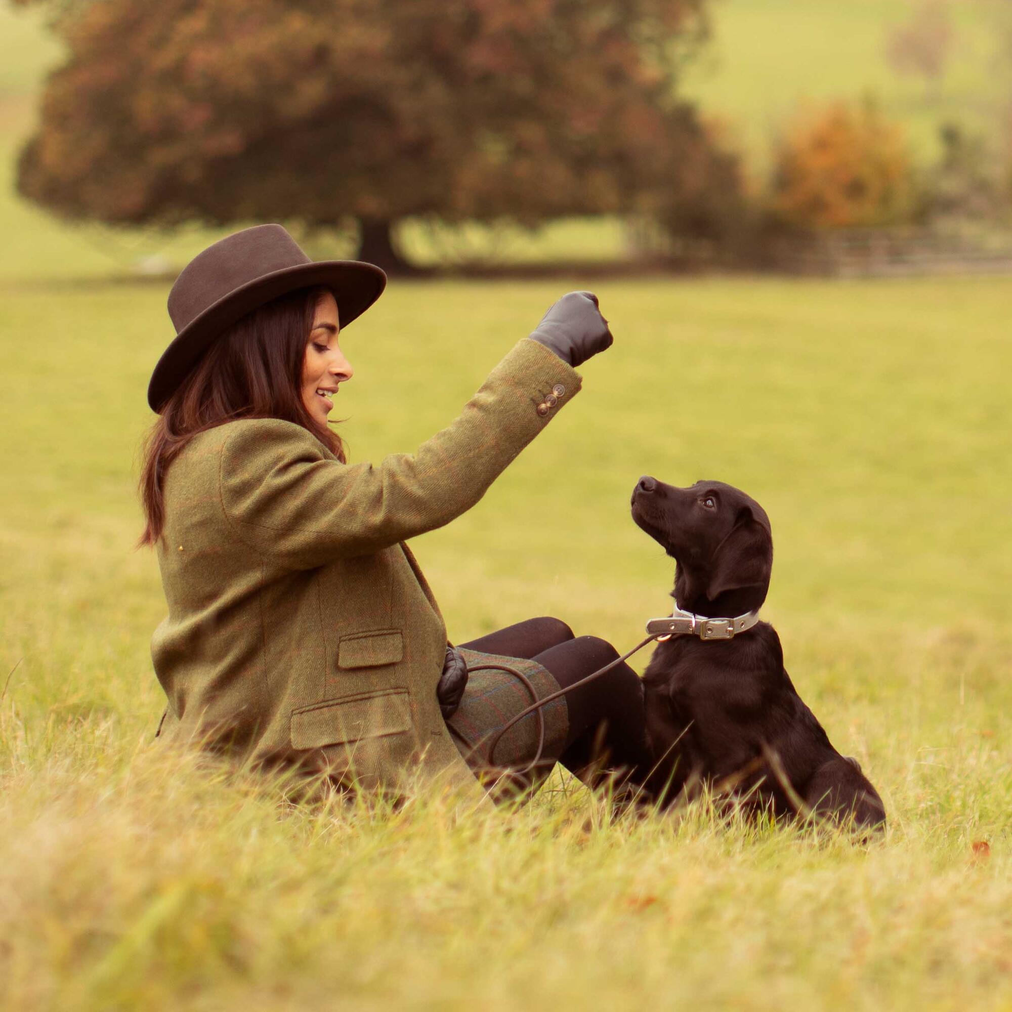Women feeding her puppy essential foods puppy treats