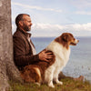 Man and his dog looking into the ocean