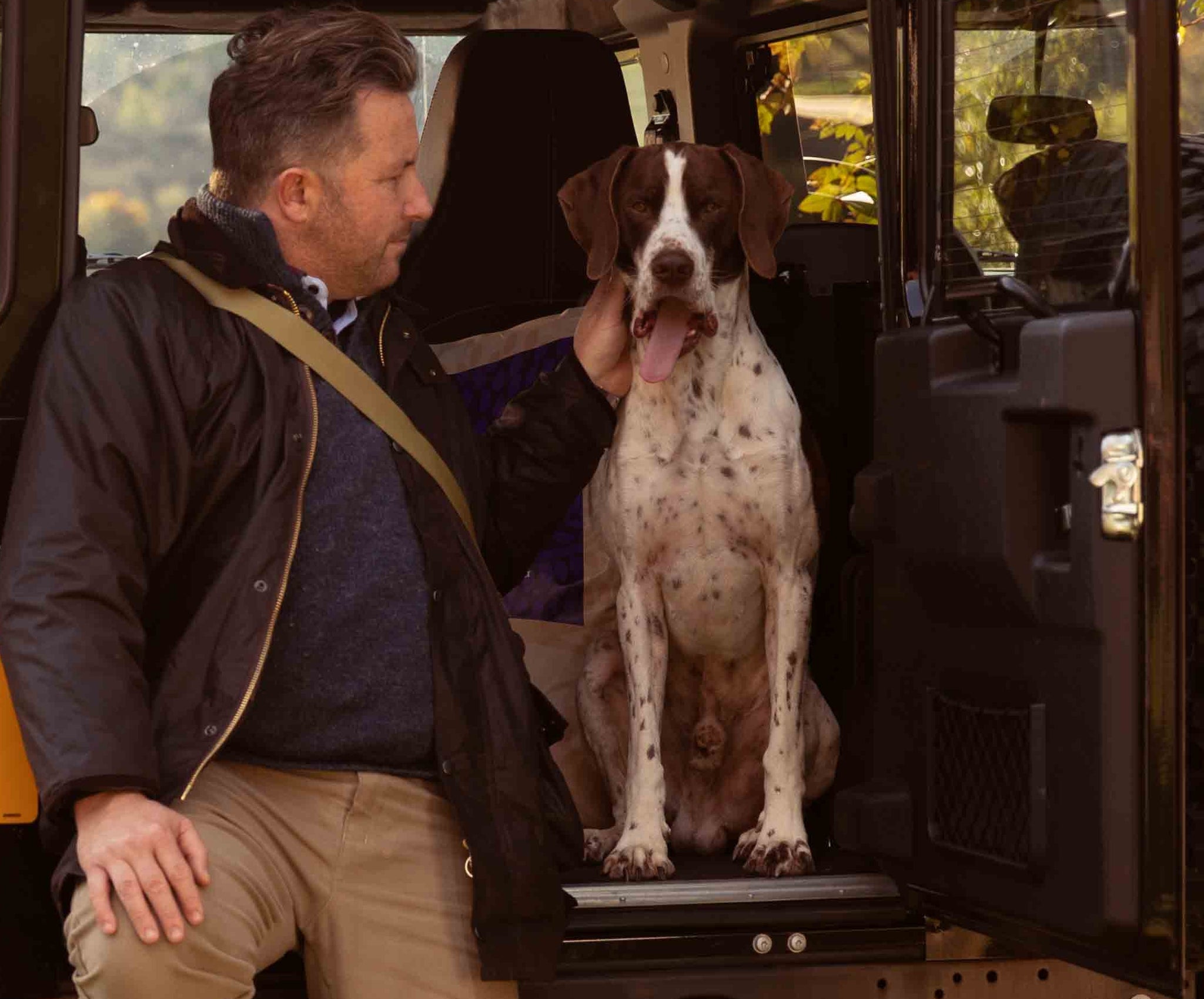 Man in his car with his dog