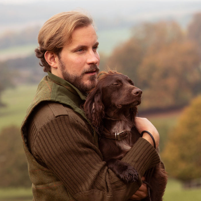 Man with Springer Spaniel in his arms