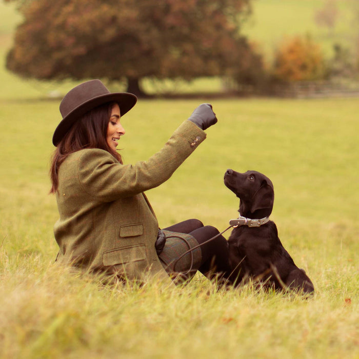 Women feeding her puppy essential foods puppy treats