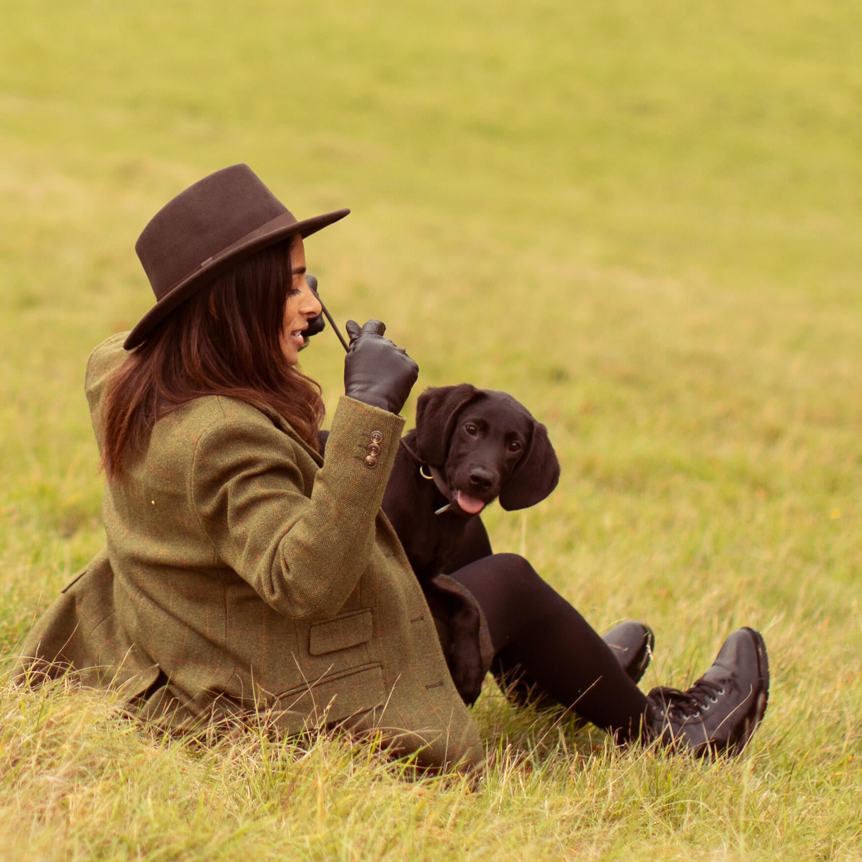 Women training her puppy to sit